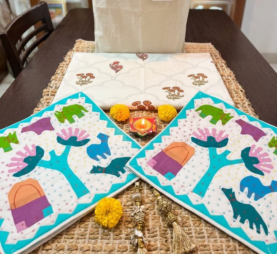 Emenaura festive cotton bedsheet set with one hand-block printed bedsheet and two embroidered cushion covers featuring animal designs.