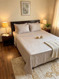 Beige bamboo bedsheet from Emenaura displayed on a neatly made bed with soft, natural fabric texture.