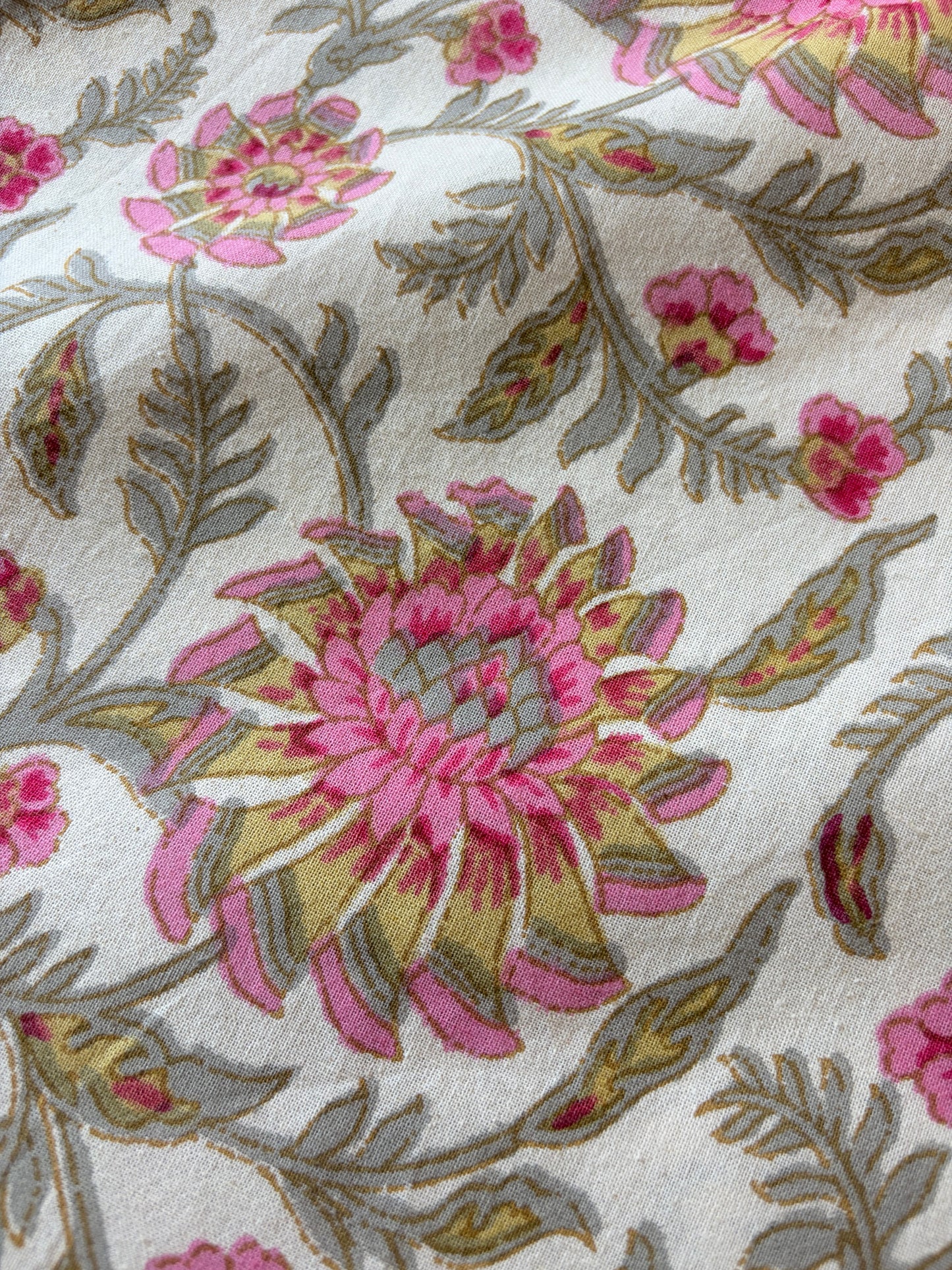 Pink floral bedsheet from Emenaura with soft fabric and vibrant flower pattern, shown spread out on a bed.