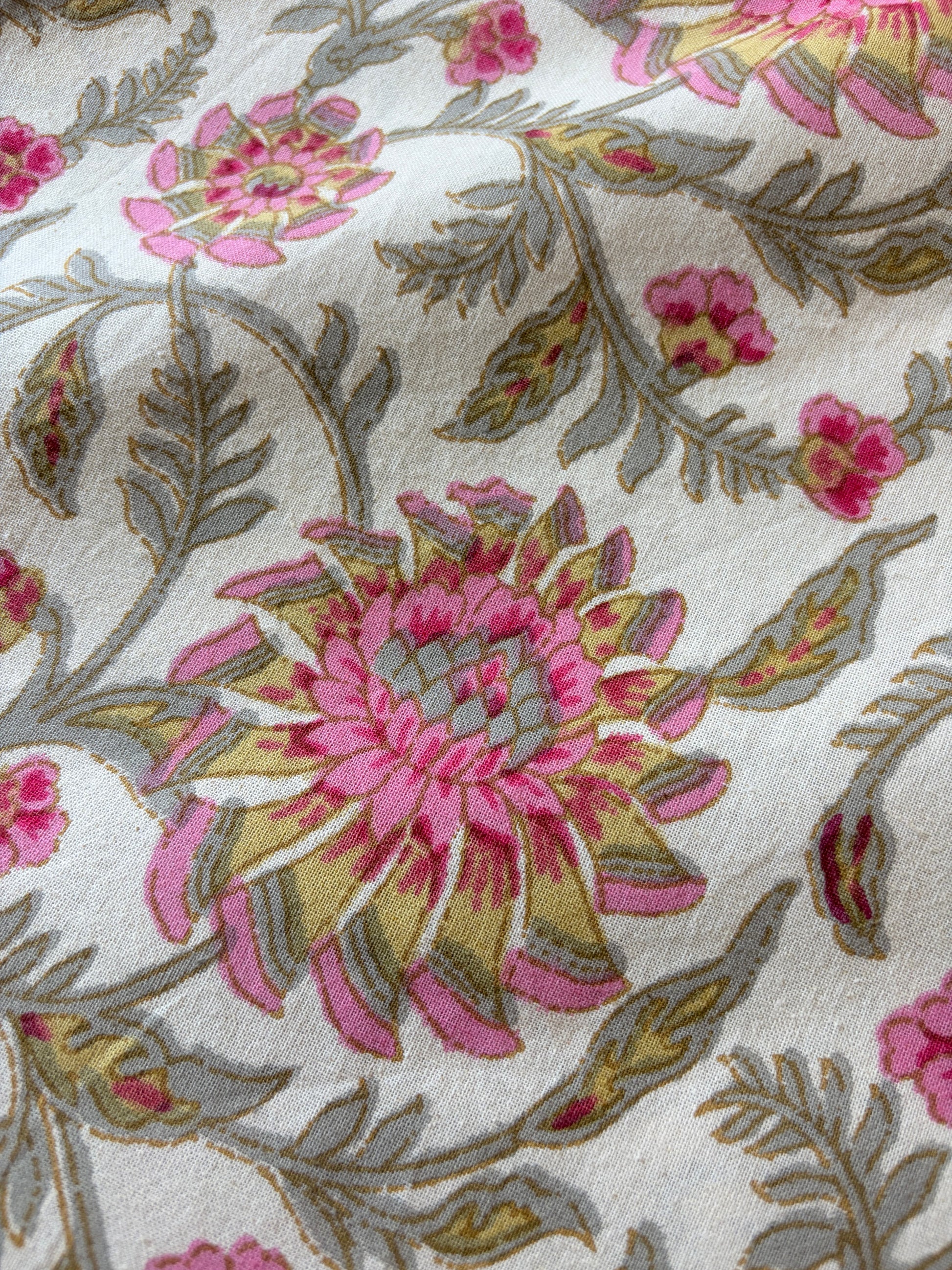 Pink floral bedsheet from Emenaura with soft fabric and vibrant flower pattern, shown spread out on a bed.