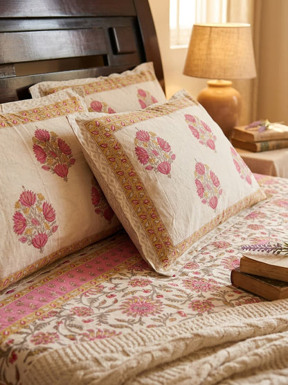 Pink floral bedsheet by Emenaura with matching pillow, showcasing a soft, vibrant floral pattern on smooth fabric.