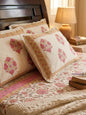 Pink floral bedsheet by Emenaura with matching pillow, showcasing a soft, vibrant floral pattern on smooth fabric.