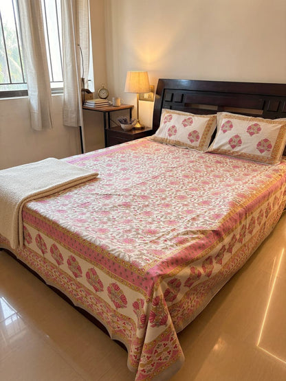 Pink floral bedsheet from Emenaura with a delicate flower pattern, neatly spread on a bed for a cozy and stylish look.