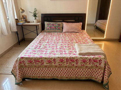 Emenaura Rosy Bloom bedsheet with floral pattern, neatly spread on a cozy, well-lit bedroom bed for a comfortable look.