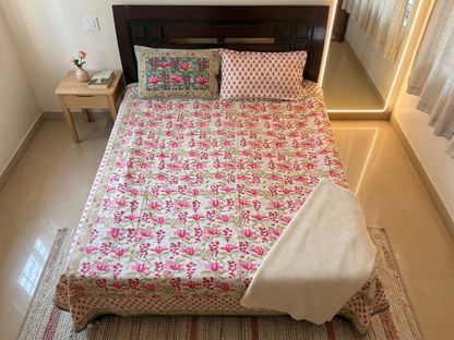 Emenaura Rosy Bloom bedsheet in a well-lit bedroom, featuring a cozy, floral design from an upper view.