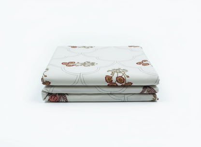 Folded Emenaura Festive Home cotton bedsheet set with embroidered cushion covers featuring colorful block printed designs.