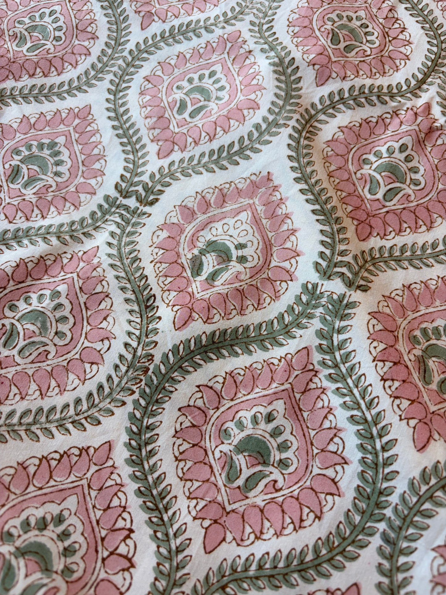 Emenaura blush geometric cotton bedsheet set with matching pillowcases, featuring modern design and soft fabric for comfort.