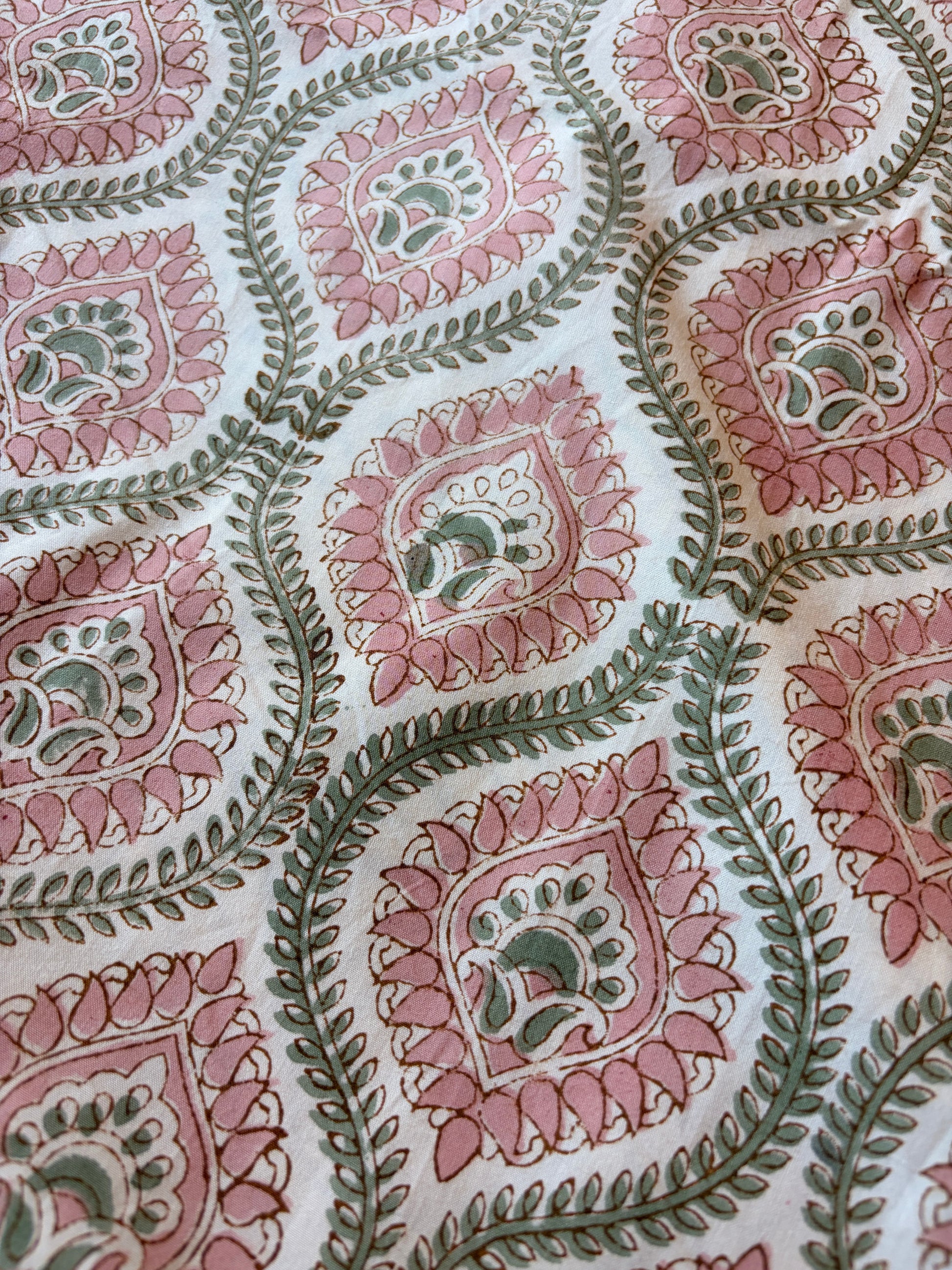 Emenaura blush geometric cotton bedsheet set with matching pillowcases, featuring modern design and soft fabric for comfort.
