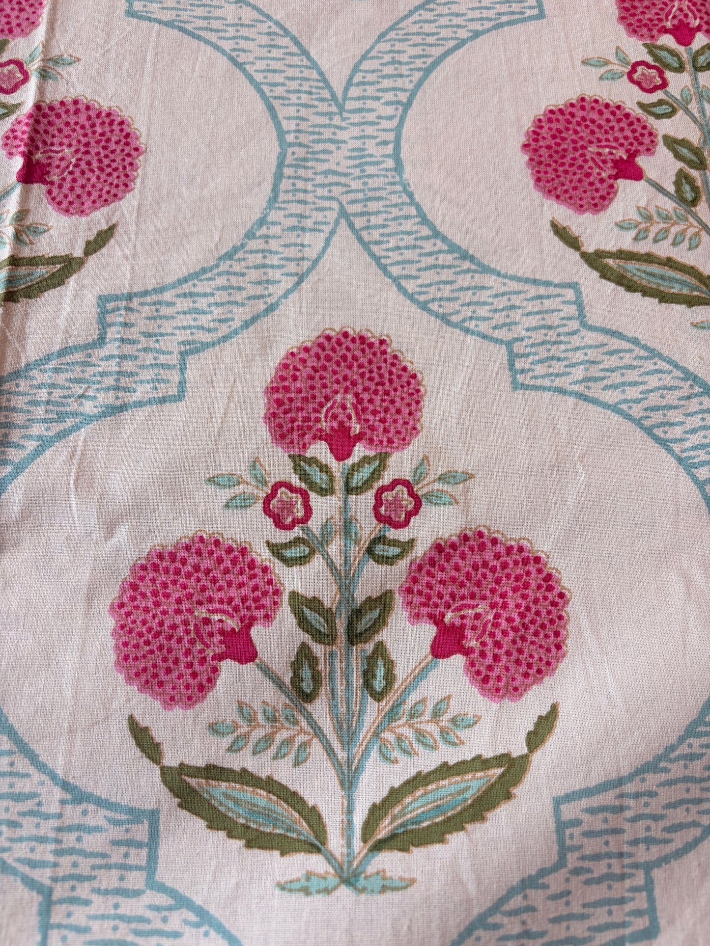 Emenaura Blossom Garden cotton bedsheet with floral pattern, soft fabric, and pastel colors draped on a bed.