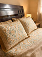 Emenaura heritage motif cotton bedsheet with decorative pillows, showcasing intricate traditional design and soft fabric texture.