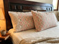 Emenaura blush geometric cotton bedsheet set with matching pillows, soft and stylish bedding for a modern bedroom decor.
