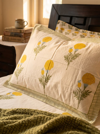 Emenaura Sunny Bloom cotton bedsheet with matching pillows in soft, vibrant floral print, showcasing a cozy bedroom setup.