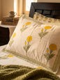 Emenaura Sunny Bloom cotton bedsheet with matching pillows in soft, vibrant floral print, showcasing a cozy bedroom setup.