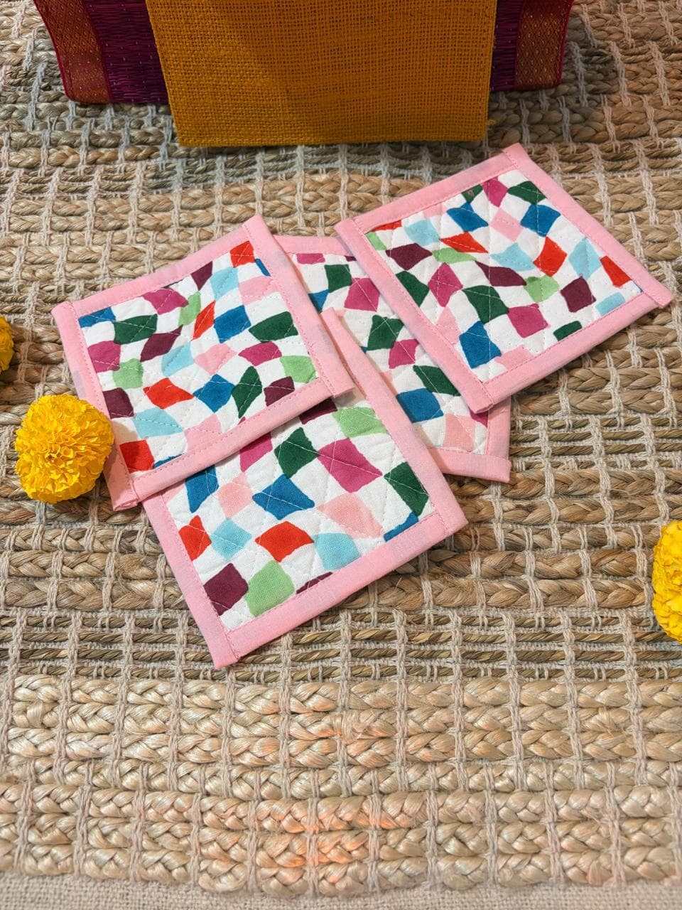 Emenaura Little Diwali coaster set with four colorful ceramic coasters in a pouch, includes a surprise gift.