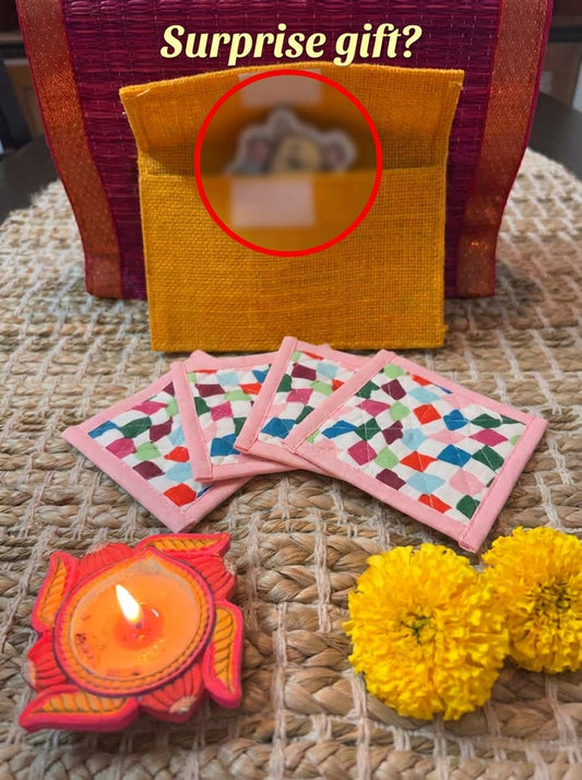 Set of four Emenaura Diwali-themed coaster set with a surprise gift in a pouch, featuring vibrant decorative designs.