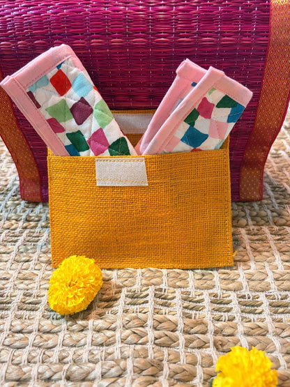 Set of four Emenaura Diwali-themed coasters in a pouch with a surprise gift, featuring colorful traditional designs.