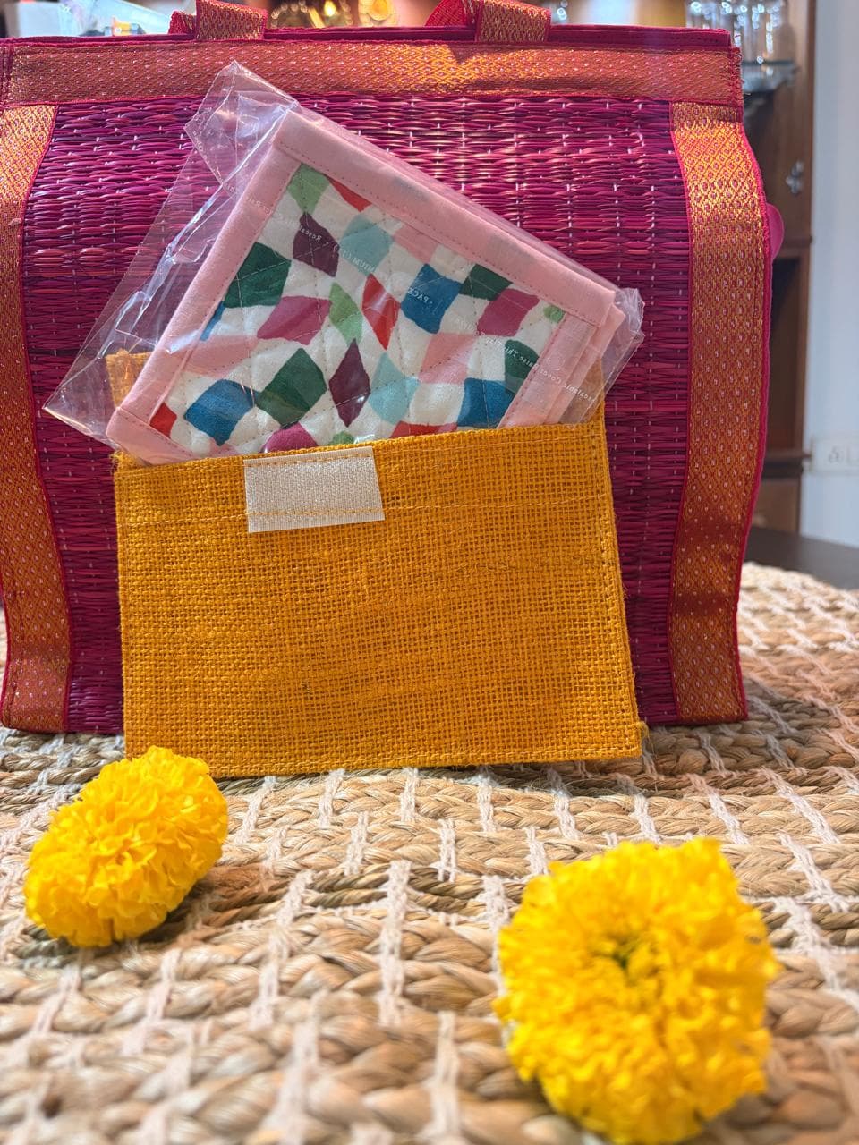 Set of four Emenaura Diwali-themed coasters with decorative designs, displayed in a pouch with a surprise gift.