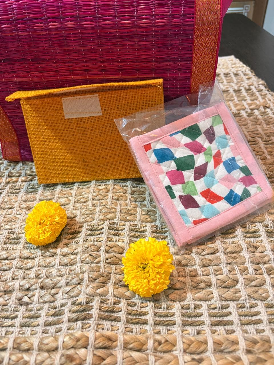 Emenaura Little Diwali coaster set with four colorful ceramic coasters in a pouch, with a surprise gift included.