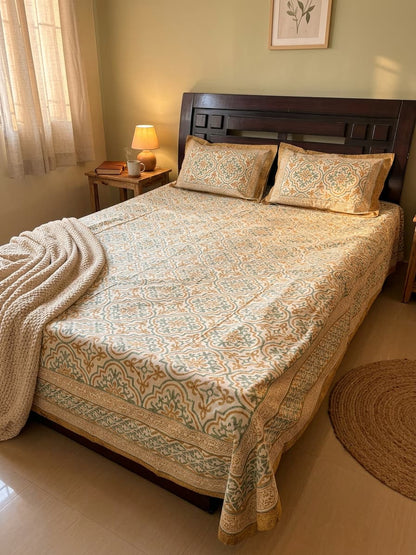 Emenaura heritage motif cotton bedsheet with intricate traditional patterns spread out on a bed.