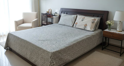 Emenaura premium cotton bedsheet set with two matching cotton cushion covers, spread out showing detailed floral pattern.