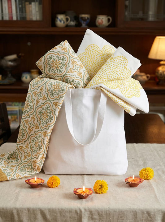 Yellow block printed bedsheet with two embroidered cotton cushion covers from Emenaura, perfect for festive home decor.