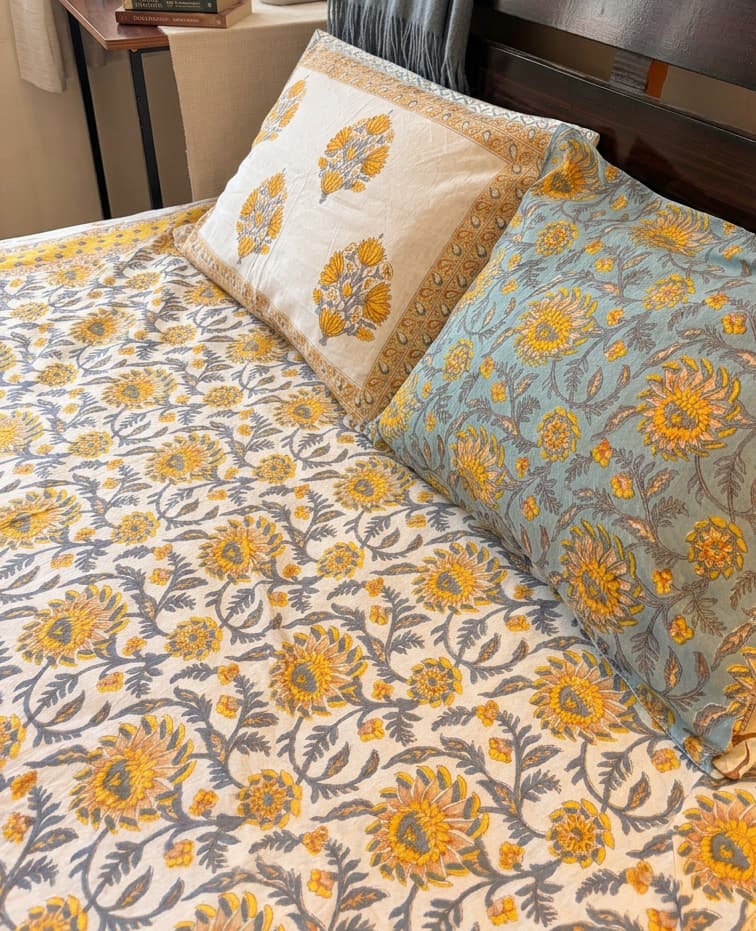 Sunlit Heritage Floral Cotton Bedsheet by Emenaura featuring vibrant floral patterns and soft cotton fabric for a cozy bedroom look.